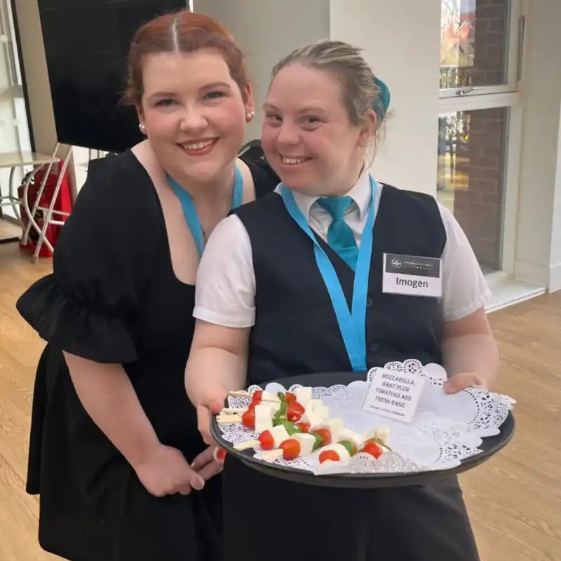 Student and staff working in a cafe