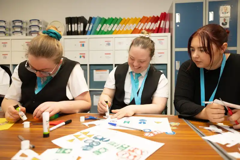 Students working on an activity with a staff member